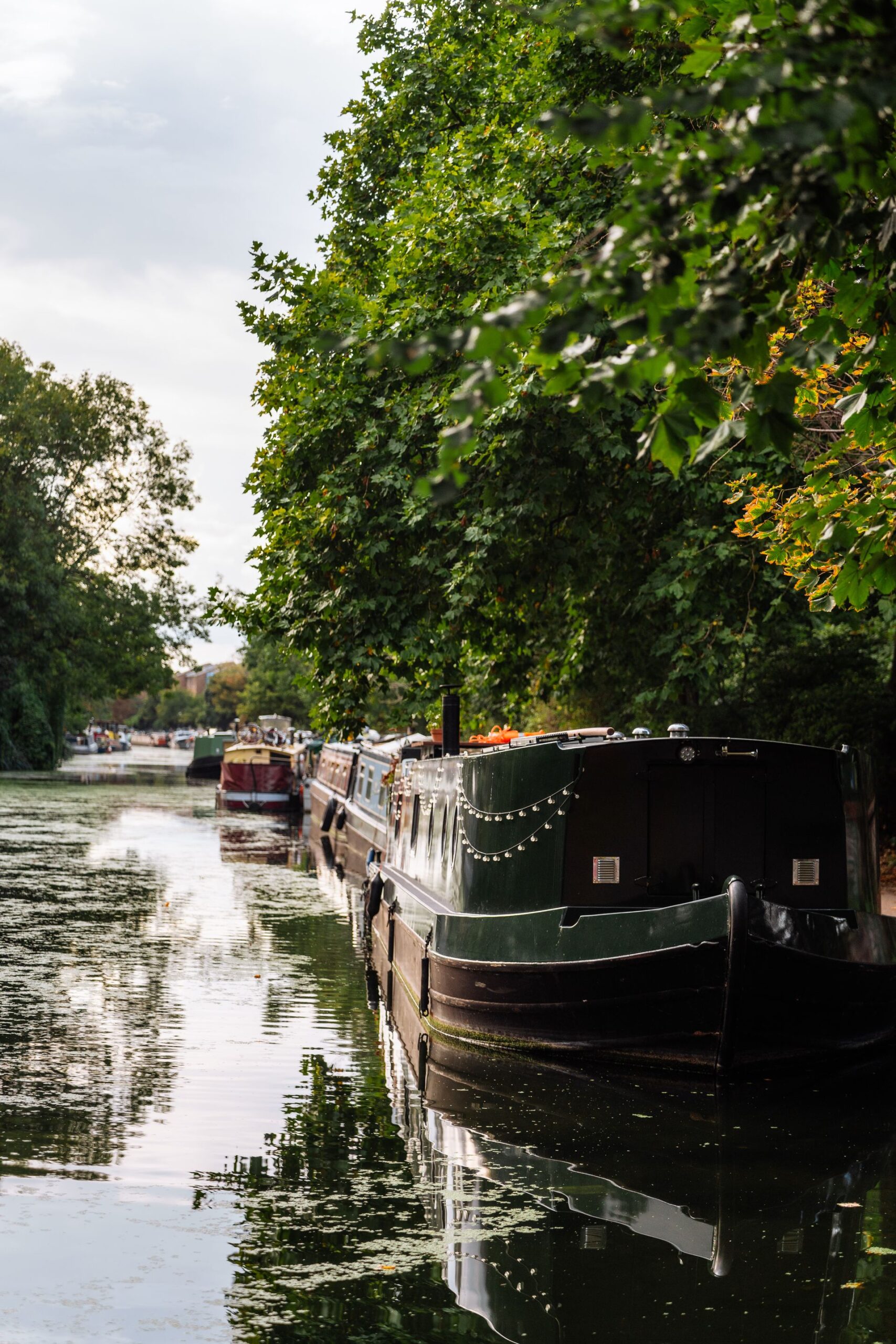 Narrowboat moored on a quiet canal at dusk