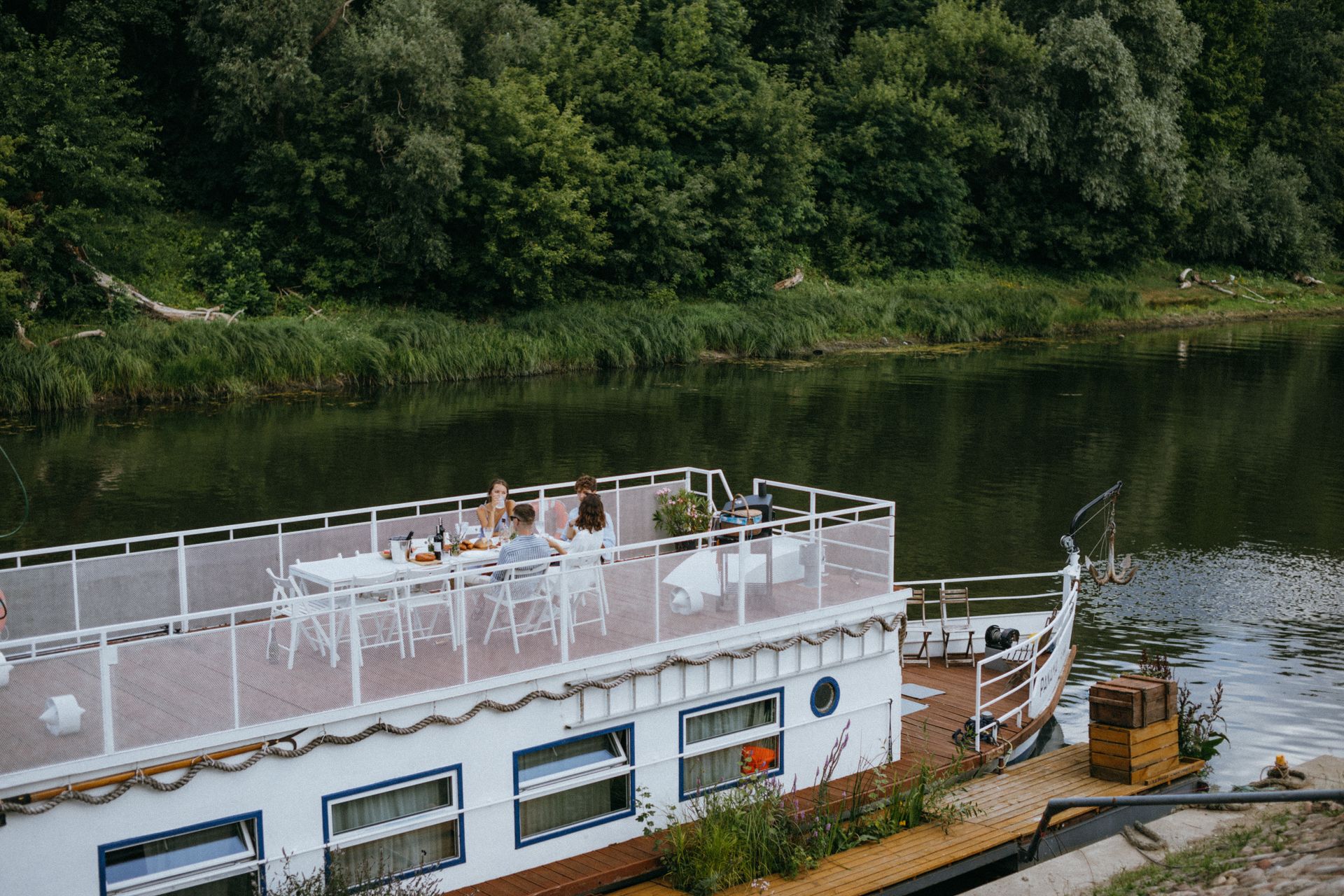 Grand class barge with spacious deck at sunset